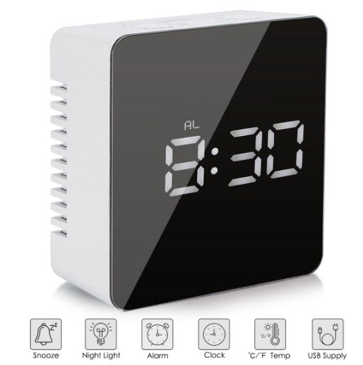 Close-up of digital time and temperature display on mirror alarm clock