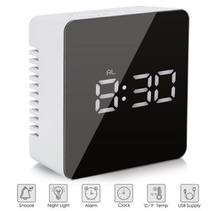 Close-up of digital time and temperature display on mirror alarm clock